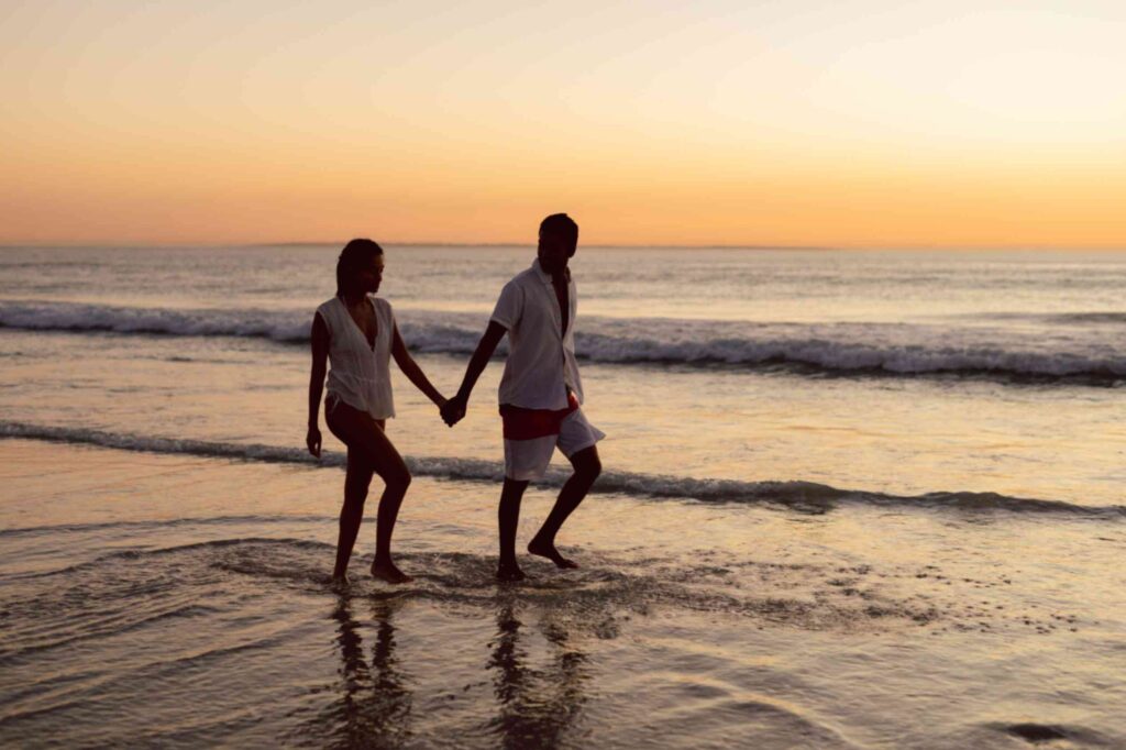 couple-walking-hand-hand-beach